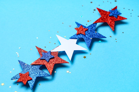Glitter stars in colors of USA flag on blue background, closeup. Independence Dayの写真素材