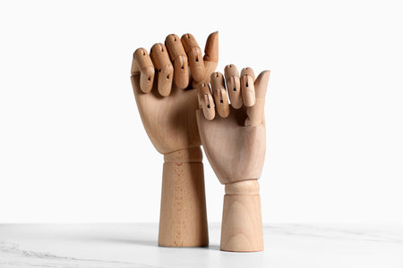 Wooden hands on white tableの写真素材