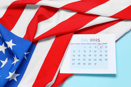 USA flag and calendar with marked 4 JULY date on blue background. Independence Day celebrationの写真素材