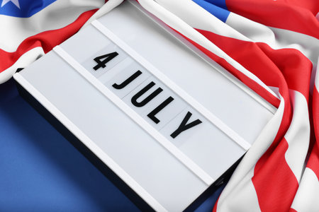 Lightbox with text 4 JULY and USA flag on blue background. Independence Day celebrationの写真素材