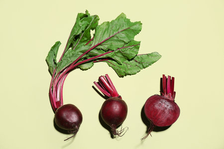Fresh baby beetroots on green background