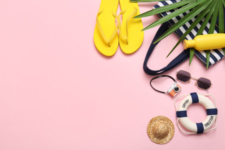 Composition with bottle of sunscreen cream and beach accessories on pink backgroundの写真素材