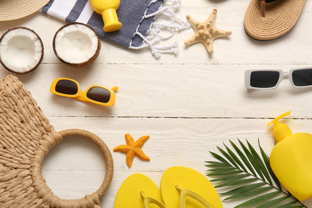 Frame made of coconuts, starfishes and beach accessories on white wooden backgroundの写真素材