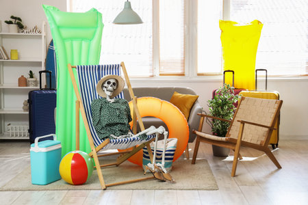 Human skeleton on deck chair with beach accessories in living room