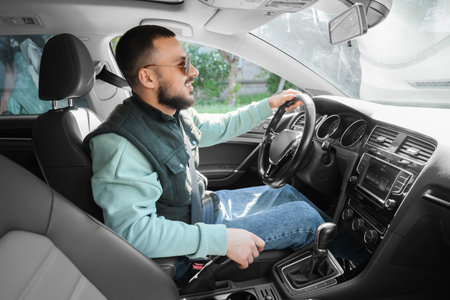Handsome young man driving a car. I love my car concept