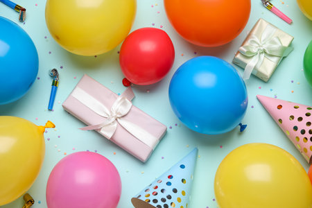 Composition with different air balloons, gift boxes and confetti on blue background, closeupの写真素材