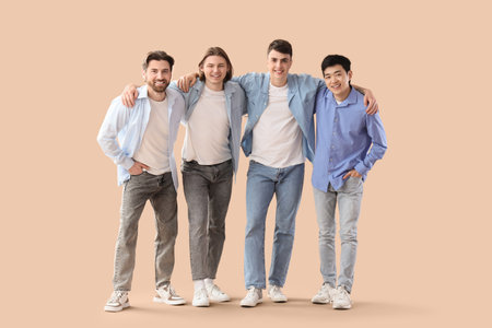 Group of young men on beige backgroundの写真素材