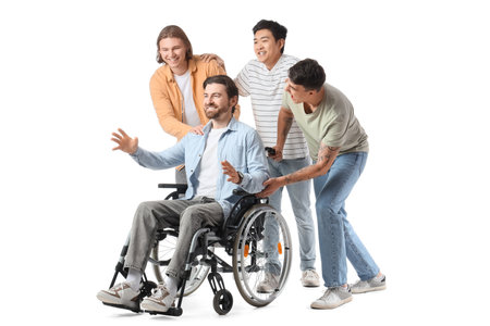 Happy friends with young man in wheelchair on white backgroundの写真素材