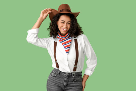 Young African-American cowgirl on green backgroundの写真素材
