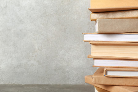 Stack of books on gray backgroundの写真素材