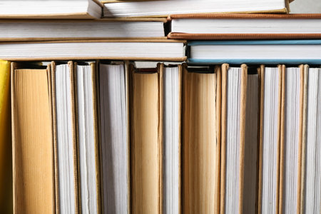 Many books on gray background, closeup