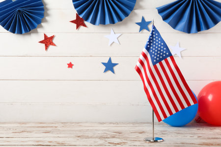 USA flag with decorations on table against white wooden background. Independence Day celebrationの写真素材