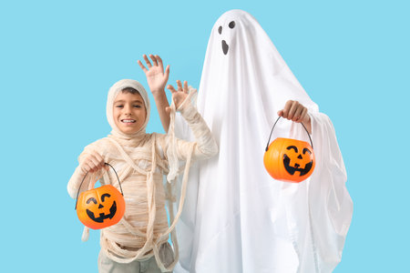 Boys dressed for Halloween on blue background