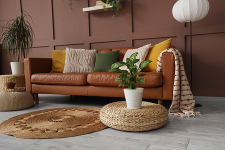 Interior of stylish living room with cozy brown sofa, poufs and houseplants