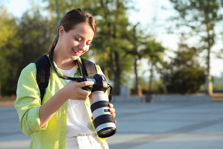 Female photographer with camera in park