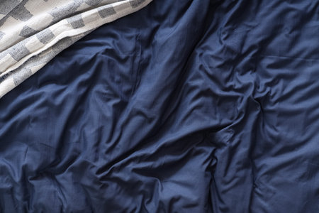 Navy blue blanket on bed, top view
