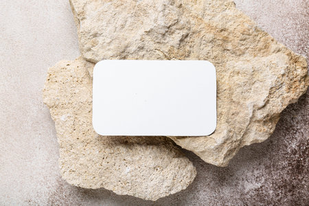 Composition with blank card and stones on beige grunge background, closeupの写真素材