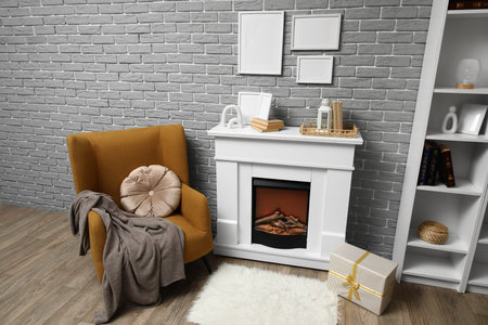 Interior of living room decorated for Christmas with armchair and fireplaceの写真素材