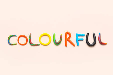 Word COLOURFUL made of play dough on light backgroundの写真素材