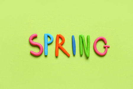 Word SPRING made of play dough on green backgroundの写真素材