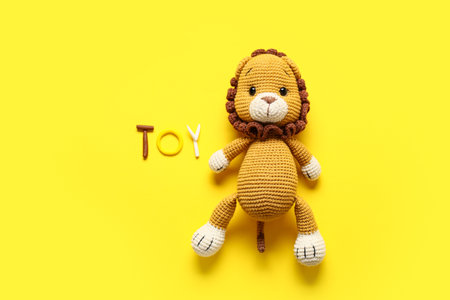 Word TOY made of and lion on yellow backgroundの写真素材