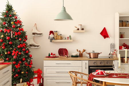 Interior of light kitchen with Christmas tree, counter and shelvesの写真素材