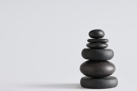 Stack of pebbles on gray background. Zen conceptの写真素材