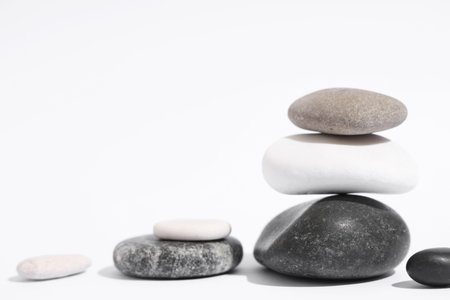 Stack of pebbles on light background. Zen conceptの写真素材