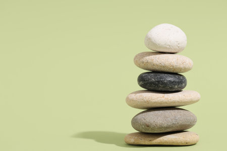 Stack of pebbles on green background. Zen conceptの写真素材