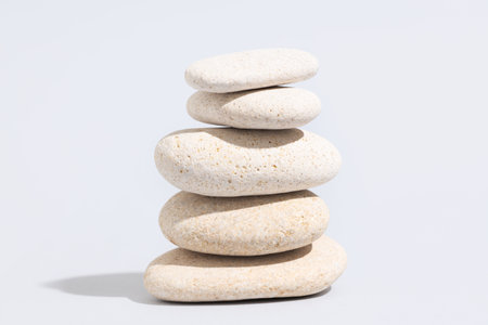 Stack of pebbles on gray background. Zen conceptの写真素材