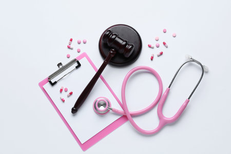 Judge gavel, clipboard, pills and stethoscope on white background. Concept of health care reformの写真素材