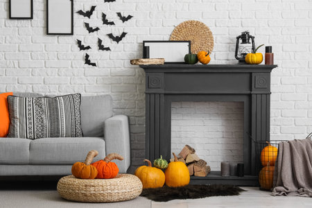 Interior of living room decorated for Halloween with fireplace, sofa and pumpkinsの写真素材