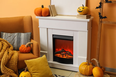 Interior of living room decorated for Halloween with fireplace, armchair and pumpkinsの写真素材