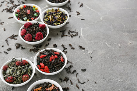 Bowls with different fruit tea on gray grunge backgroundの写真素材