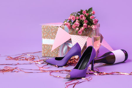 High heels with champagne, Birthday gift and decor on lilac backgroundの写真素材
