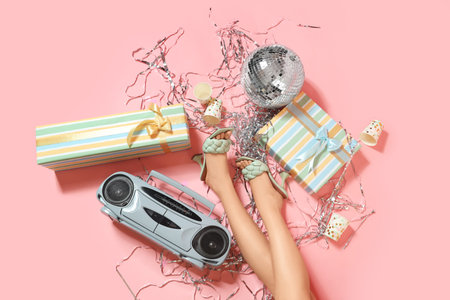 Legs of woman with boombox and party decor on pink backgroundの写真素材
