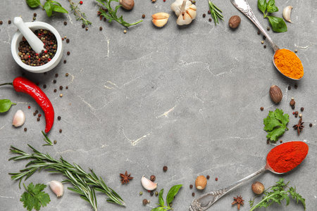 Frame made of herbs and spices on gray grunge background, closeupの写真素材