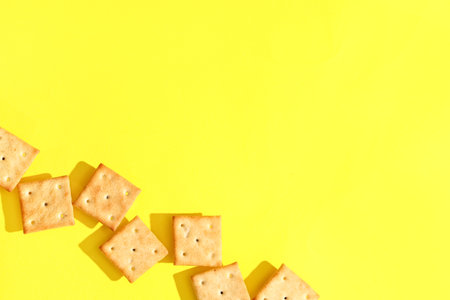 Composition with tasty crackers on yellow backgroundの写真素材