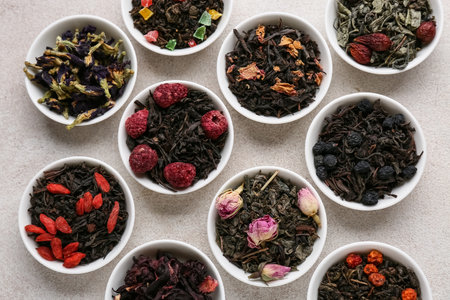 Bowls with different fruit tea on light grunge backgroundの写真素材