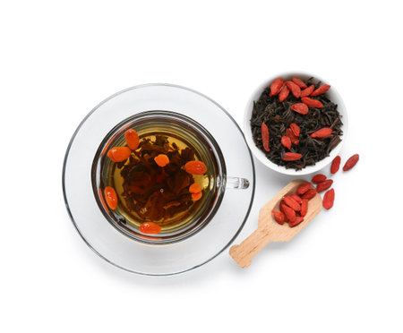 Cup and bowl with healthy goji tea on white backgroundの写真素材