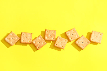 Composition with tasty crackers on yellow backgroundの写真素材
