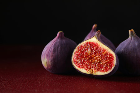 Fresh ripe figs on a red tableの写真素材
