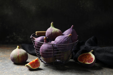 Basket with fresh ripe figs on grunge table