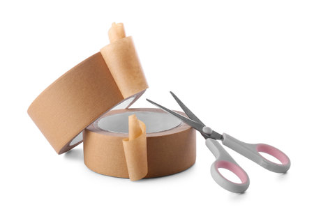 Rolls of brown masking tape with scissors on white backgroundの写真素材