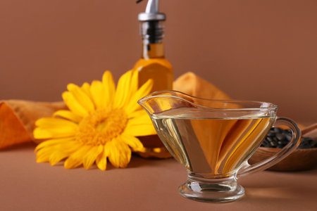 Gravy boat of sunflower oil on brown backgroundの写真素材