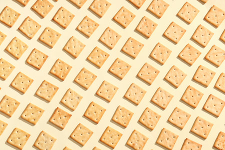 Tasty salty crackers on beige backgroundの写真素材