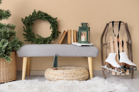 Interior of festive hallway with gray bench, sled and Christmas decorの写真素材