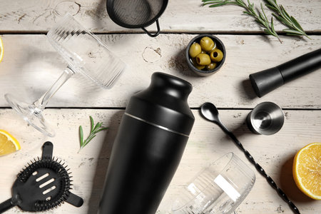 Bartender equipment, glasses and ingredients for cocktail on beige wooden background, closeupの写真素材