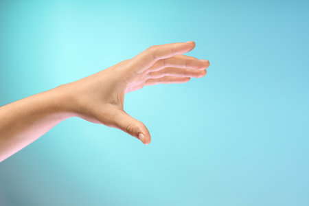 Female hand on blue backgroundの写真素材