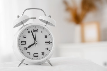 Alarm clock on table in room, closeupの写真素材